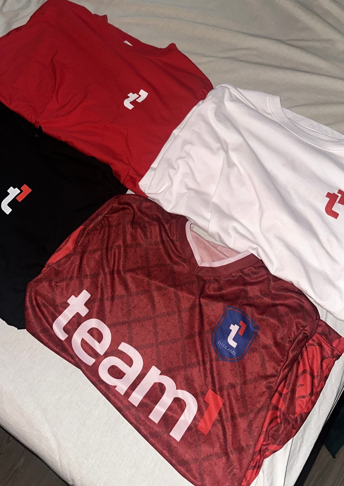 Team1 branded red jersey detail